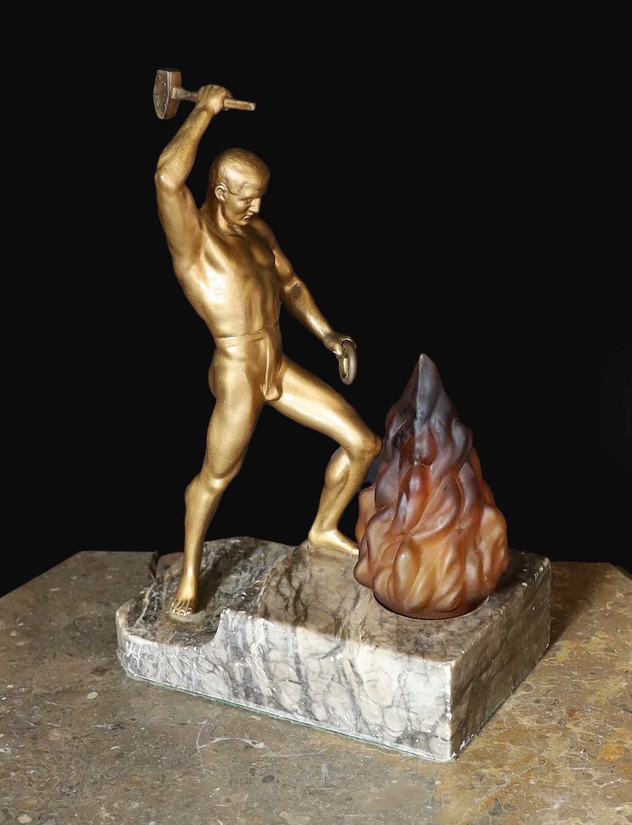 A 1930s Austrian bronzed spelter and marble lamp base modelled as Vulcan, stamped Bergman to the foot, height 32cm